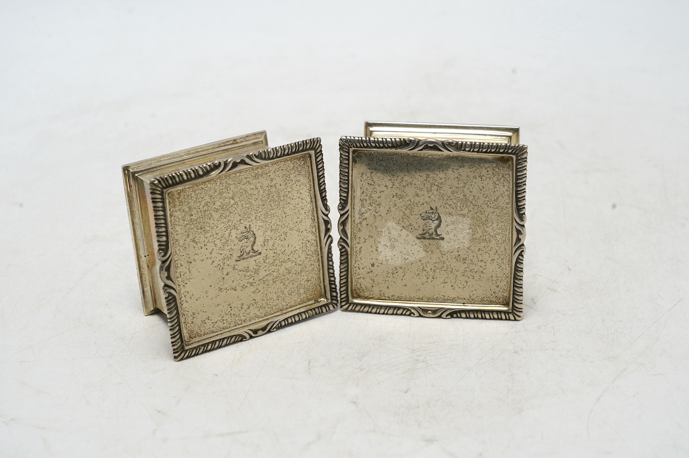 A pair of George V silver square boxes with hinged covers, by Goldsmiths & Silversmiths Co Ltd, London, 1914, 59mm, 7.2oz. Condition - good